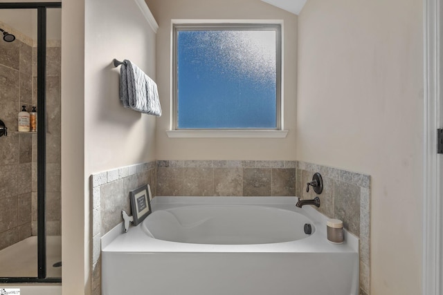 bathroom featuring shower with separate bathtub