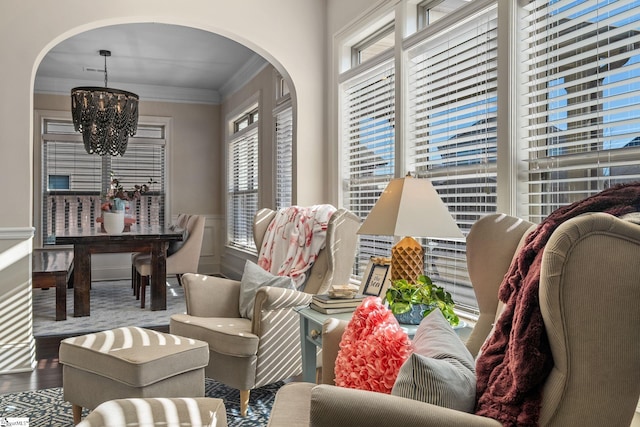 living room featuring ornamental molding, hardwood / wood-style flooring, and a notable chandelier