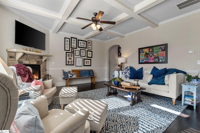 living room featuring hardwood / wood-style flooring, beam ceiling, ornamental molding, and coffered ceiling