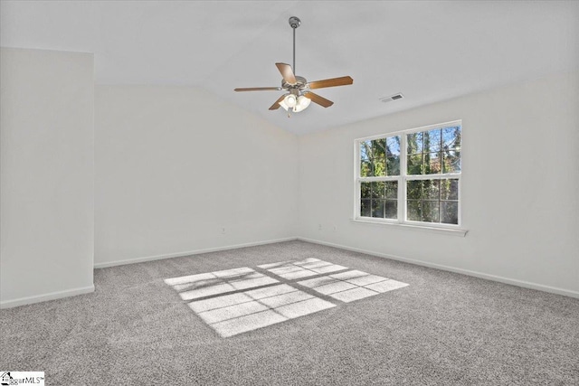 carpeted spare room featuring ceiling fan and vaulted ceiling