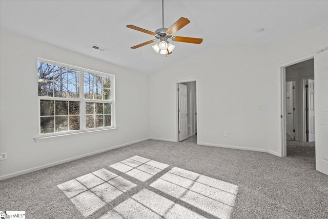 unfurnished bedroom featuring light carpet, vaulted ceiling, and ceiling fan