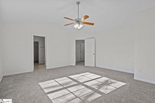 unfurnished bedroom with carpet, ceiling fan, and vaulted ceiling