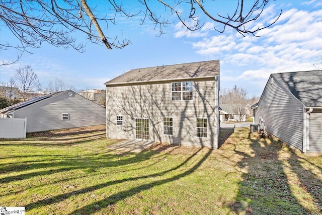 back of house featuring a lawn and a patio area