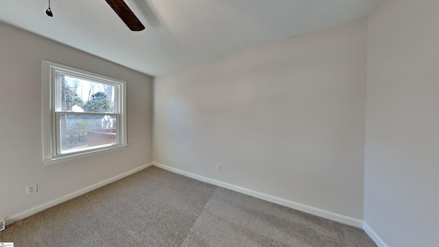 unfurnished room with light colored carpet and ceiling fan