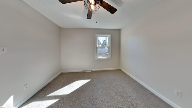 empty room featuring carpet floors and ceiling fan