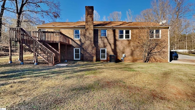 back of house with a yard, central AC unit, and a deck