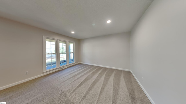 empty room with light colored carpet