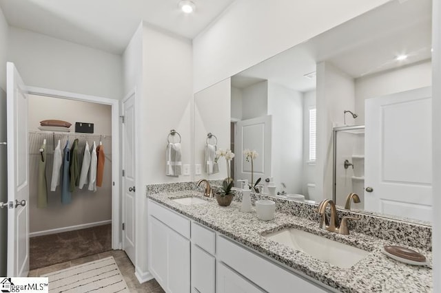 bathroom with vanity, an enclosed shower, and toilet