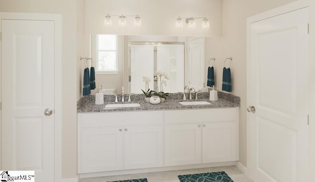 bathroom with tile patterned floors, vanity, and an enclosed shower