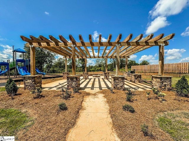 view of yard with a pergola and a playground