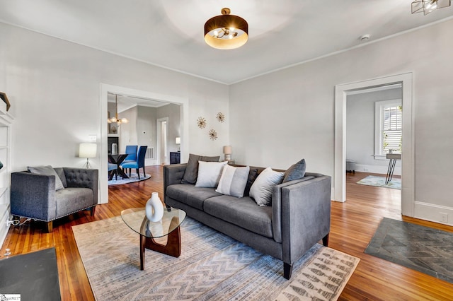 living room featuring wood-type flooring and a notable chandelier