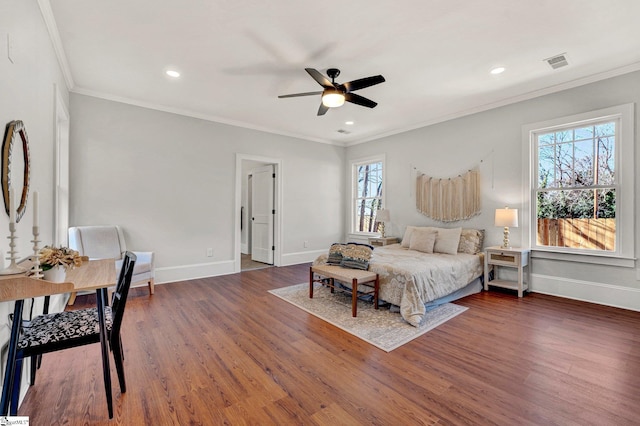 bedroom featuring dark hardwood / wood-style flooring, ceiling fan, and ornamental molding