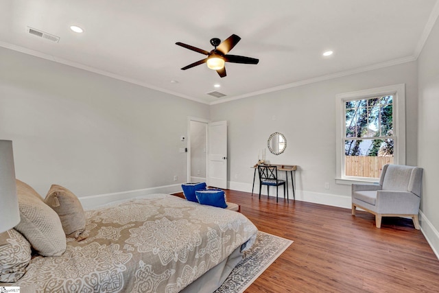 bedroom with hardwood / wood-style flooring, ceiling fan, and crown molding