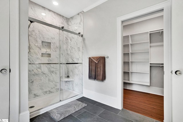 bathroom featuring tile patterned flooring, walk in shower, and ornamental molding