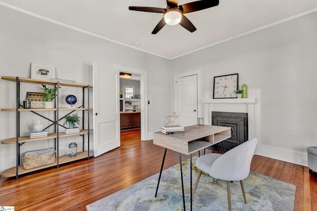 office space featuring ceiling fan, wood-type flooring, and crown molding