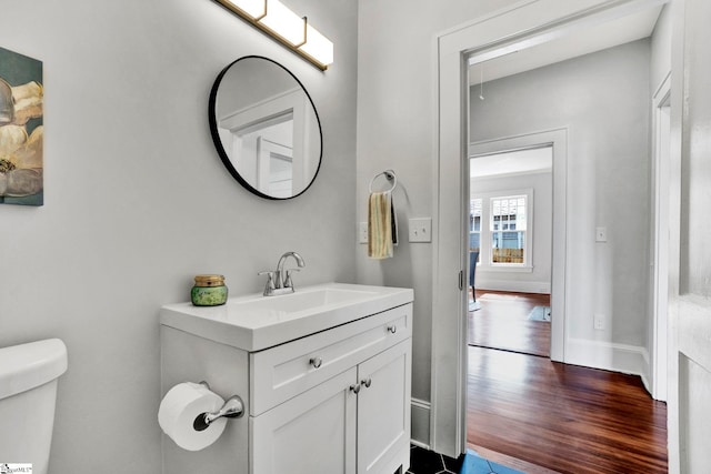 bathroom with vanity, hardwood / wood-style flooring, and toilet