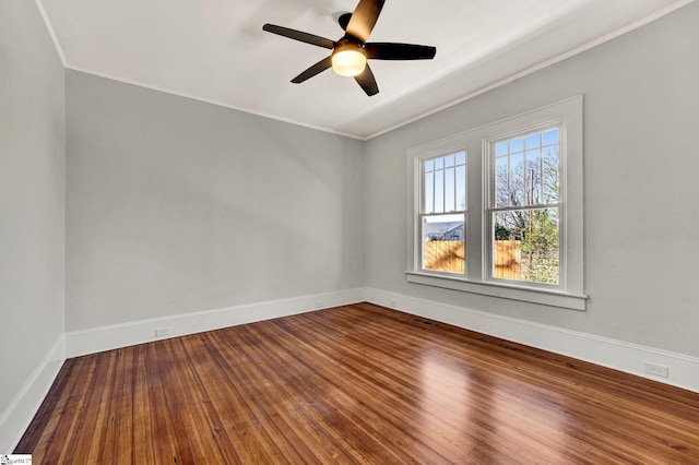 empty room with hardwood / wood-style flooring, ceiling fan, a healthy amount of sunlight, and ornamental molding