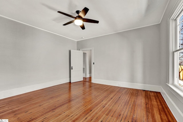 empty room with ceiling fan, wood-type flooring, and ornamental molding