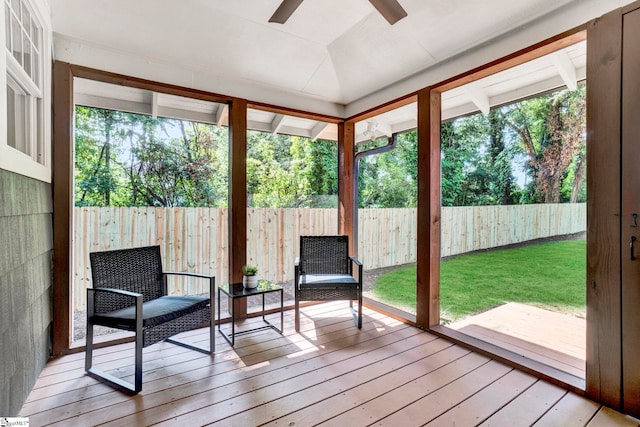 sunroom / solarium with ceiling fan and vaulted ceiling