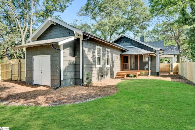 back of house with a yard