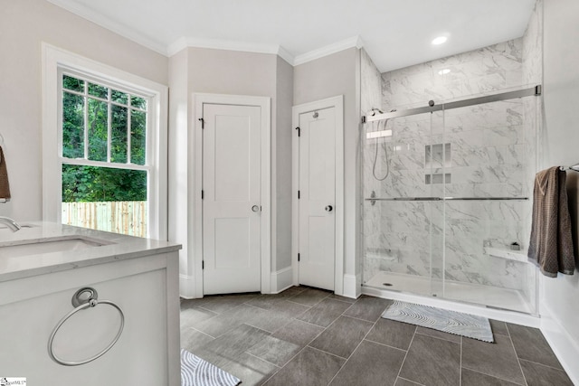 bathroom with vanity, an enclosed shower, and crown molding