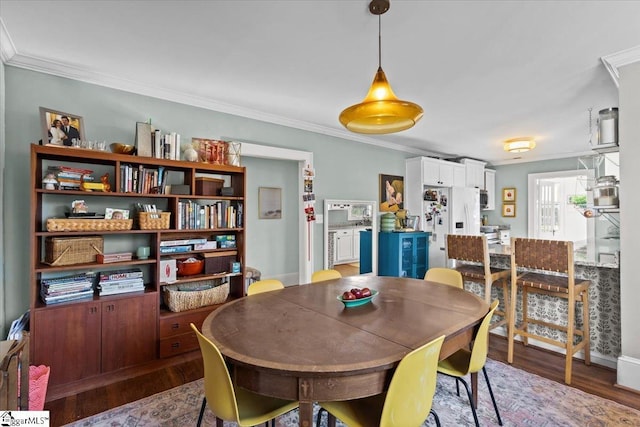 dining area featuring crown molding and wood-type flooring