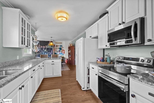 kitchen featuring appliances with stainless steel finishes, dark hardwood / wood-style floors, light stone countertops, and white cabinets