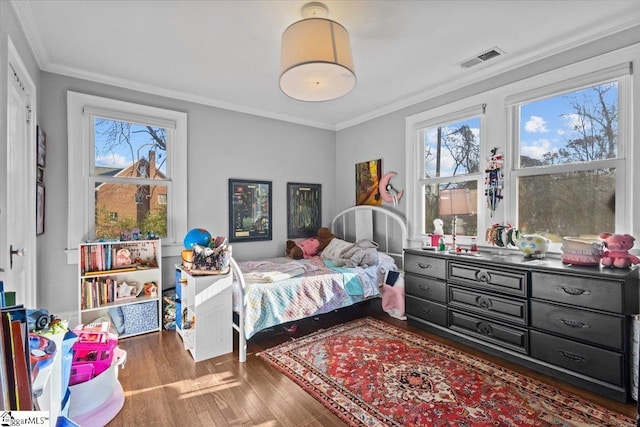 bedroom featuring multiple windows, dark wood-type flooring, and ornamental molding