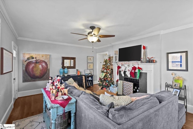 living room with wood-type flooring, ornamental molding, and ceiling fan