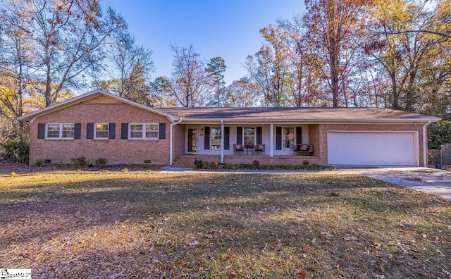 single story home with a porch, a garage, and a front yard