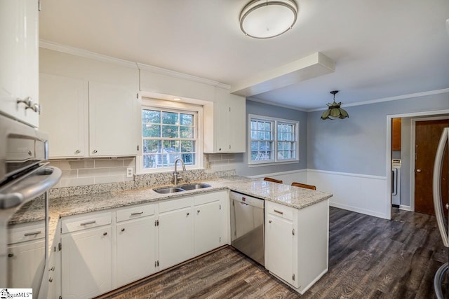 kitchen featuring kitchen peninsula, light stone counters, stainless steel dishwasher, sink, and white cabinetry