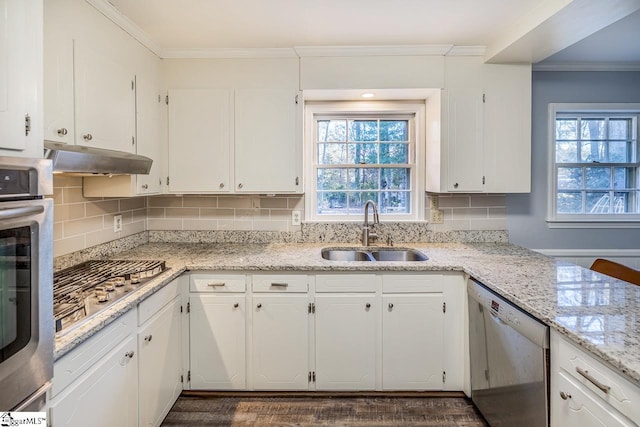 kitchen featuring decorative backsplash, white cabinetry, sink, and stainless steel appliances