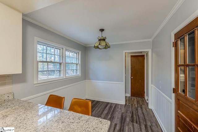 unfurnished dining area with dark hardwood / wood-style flooring and ornamental molding