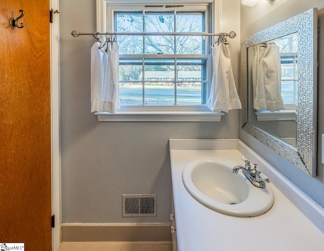 bathroom featuring a wealth of natural light and vanity