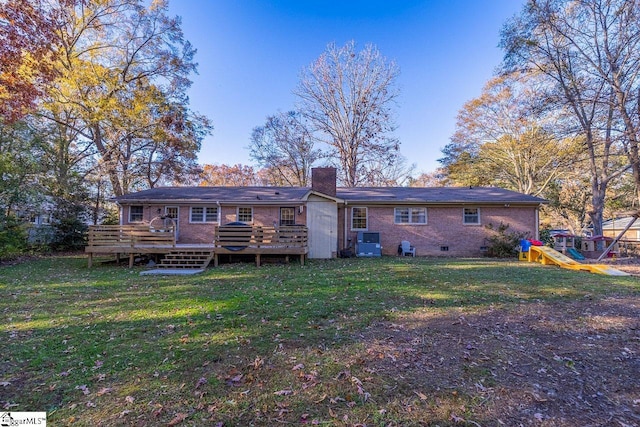 back of house with a playground, central air condition unit, a yard, and a wooden deck