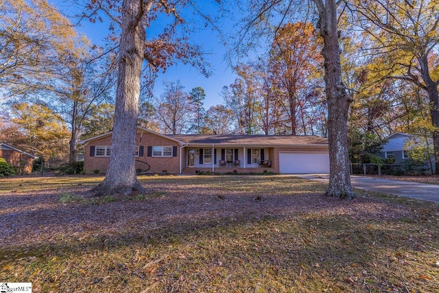 ranch-style house featuring a porch and a garage