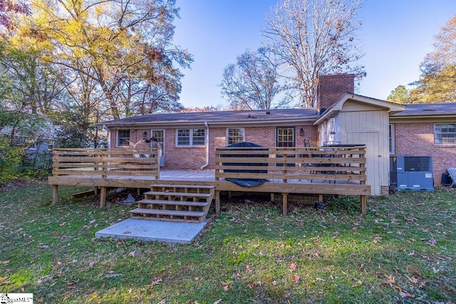 rear view of property with a deck and a yard