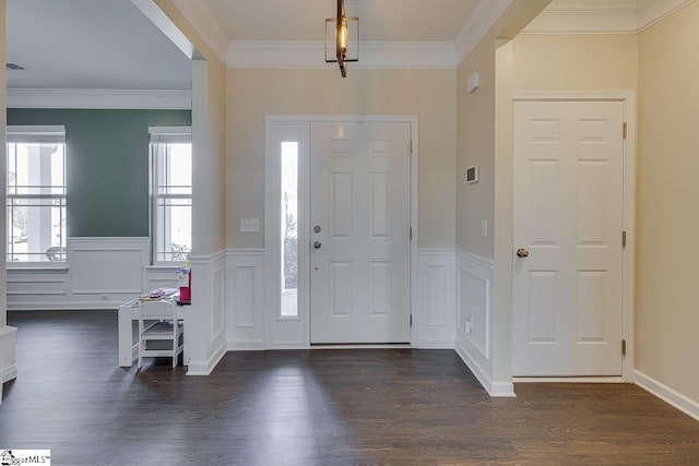 entrance foyer featuring crown molding and dark wood-type flooring