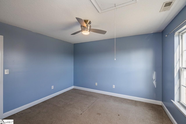 unfurnished room with ceiling fan, carpet floors, and a textured ceiling