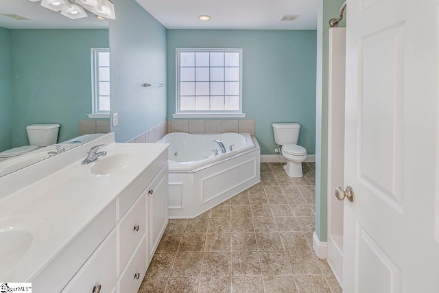 bathroom with a tub to relax in, toilet, and a wealth of natural light