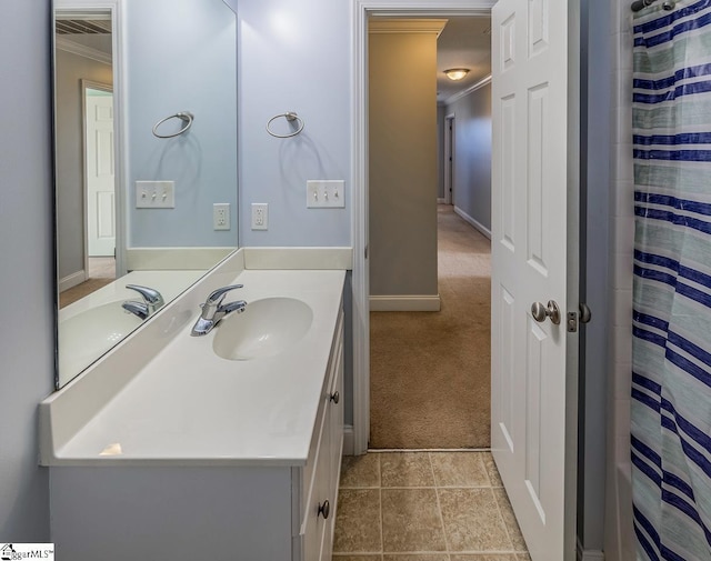 bathroom featuring a shower with shower curtain, vanity, and ornamental molding