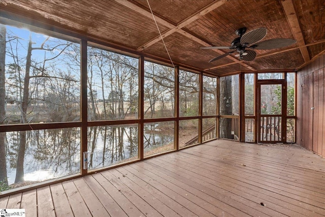 unfurnished sunroom with a water view, plenty of natural light, and ceiling fan