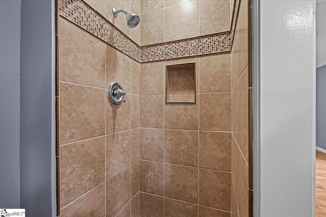 interior details with a tile shower