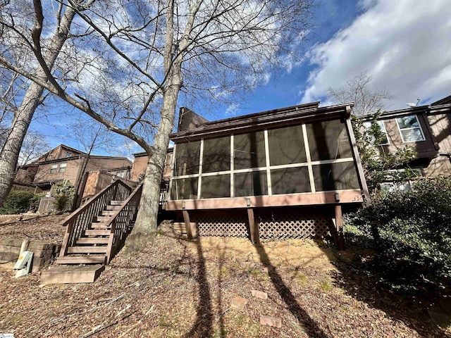 rear view of house with a sunroom