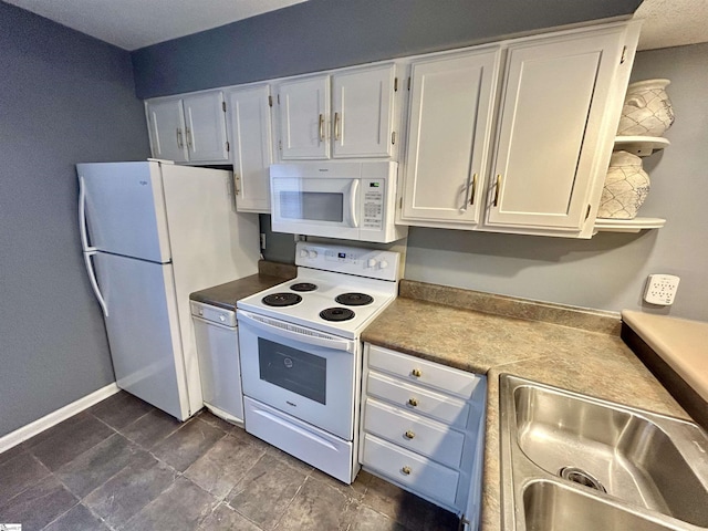 kitchen featuring white cabinets, white appliances, and sink