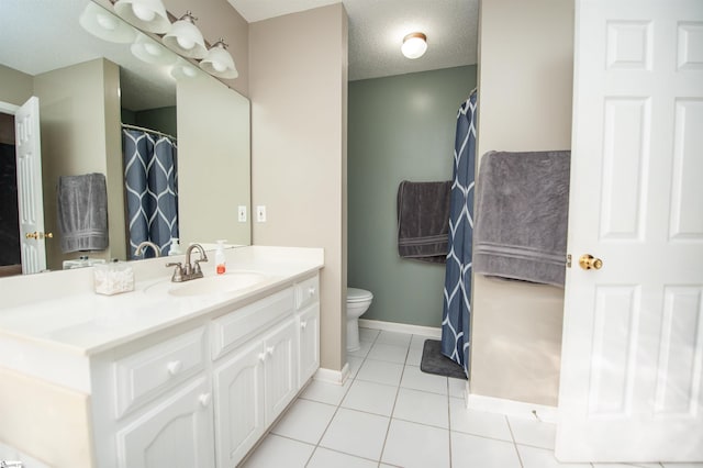 bathroom featuring tile patterned floors, vanity, a textured ceiling, and toilet