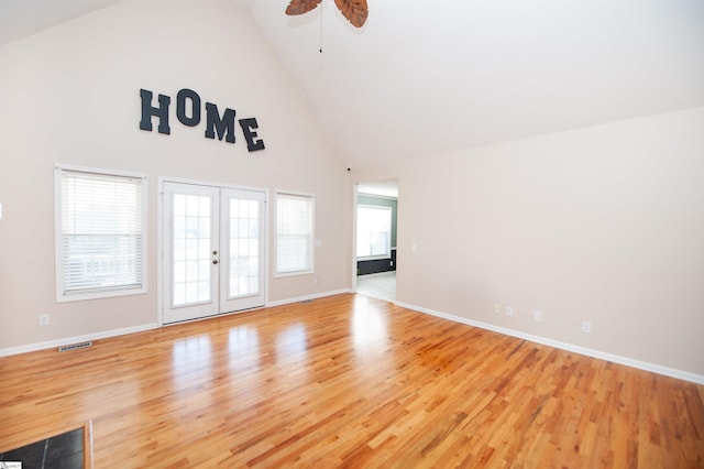 empty room featuring ceiling fan, french doors, high vaulted ceiling, and light hardwood / wood-style floors