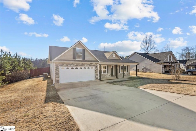 view of front of property featuring a porch, a garage, a front yard, and cooling unit