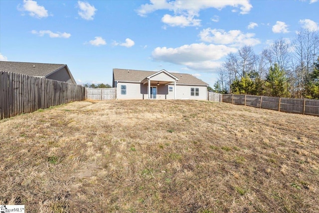 back of house featuring a yard