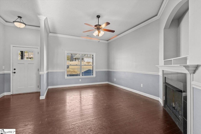 unfurnished living room with ceiling fan, dark hardwood / wood-style flooring, and ornamental molding